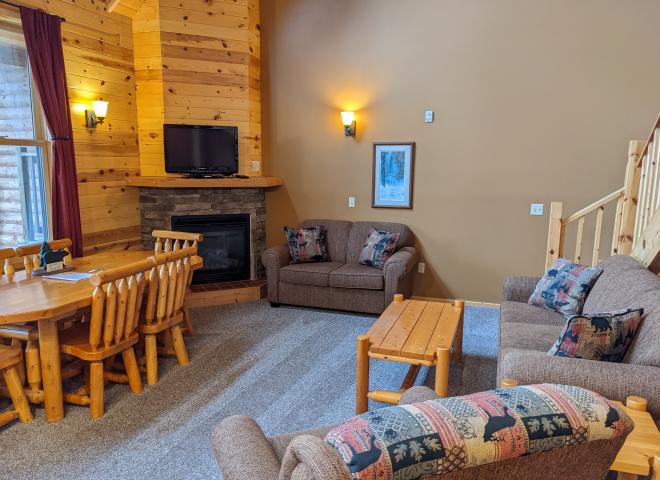 Living room with couch, loveseat, recliner, gas fireplace, and TV with streaming capabilities.