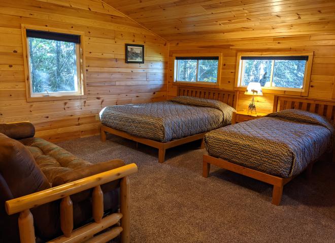 Upstairs bedroom with a queen, twin, futon, and ensuite bathroom.