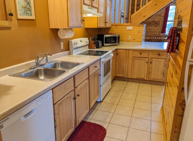 Kitchen with a refrigerator, stove, and dishwasher.