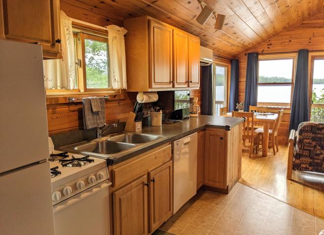 Kitchen area with a refrigerator, gas stove, and dishwasher.