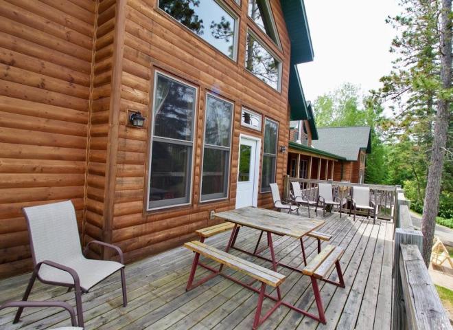 Deck area with seating, picnic table and views of the harbor.