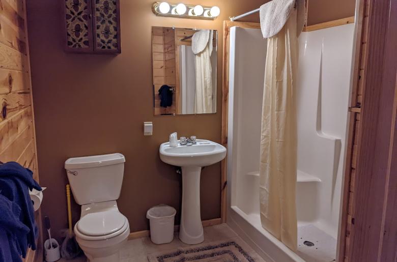 Main floor bathroom with a wide door and easy access shower and sink.