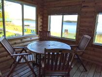 Three season porch with seating that overlooks the beach.