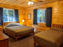 Main floor bedroom with a queen and twin bed.